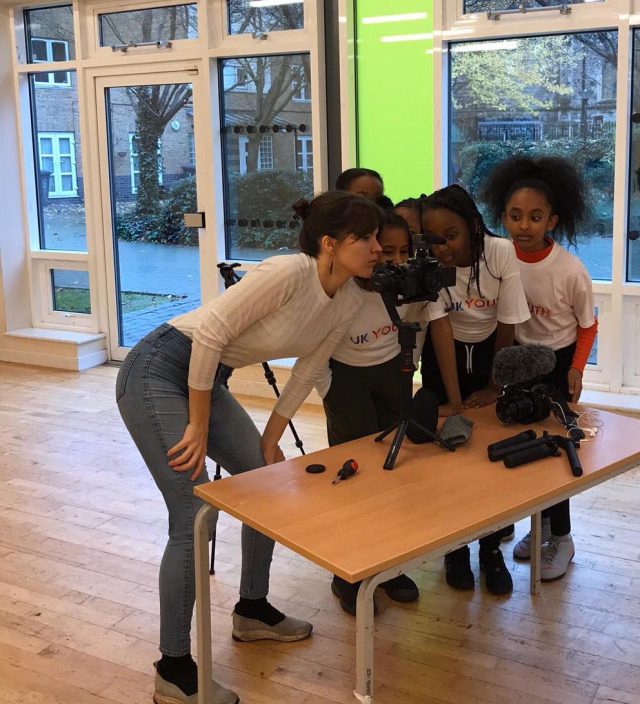 Showing students learning how to use a video camera