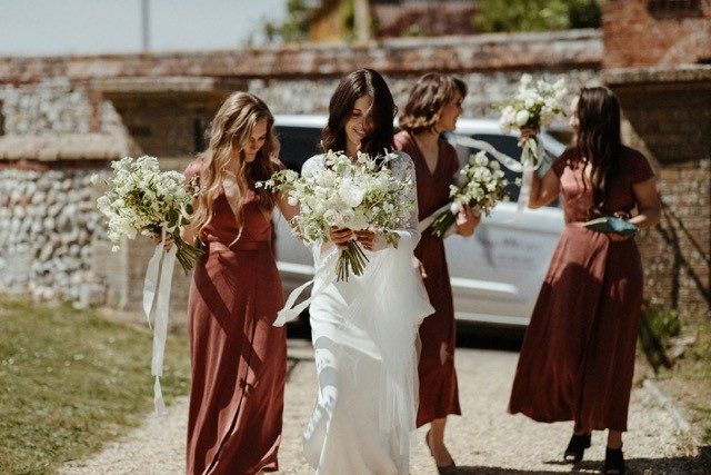 Wedding photo, showing a bride carrying photos