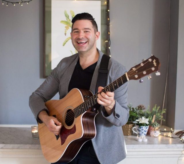 photo of man playing the guitar